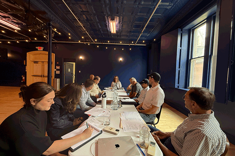 people sitting around a table in the Blue Room